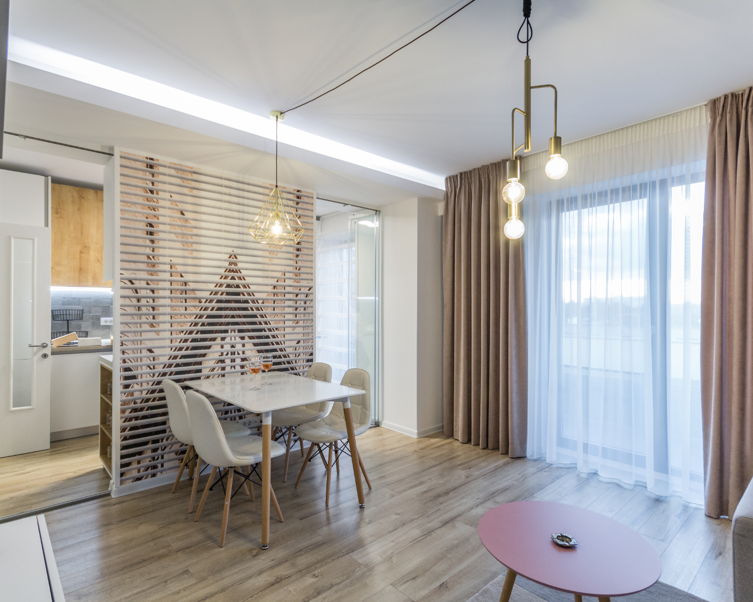 amenajare open space cu bucătărie separată de living prin geam. Zonă de dining. Stil scandinav