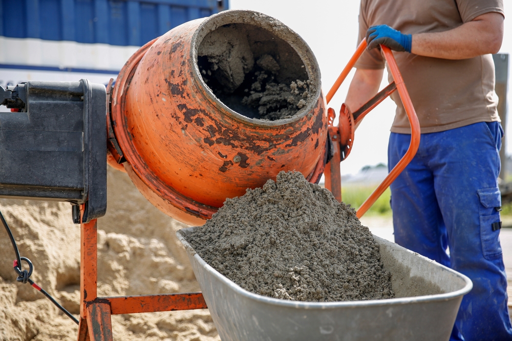 beton proaspăt din malaxor turnat de muncitor 